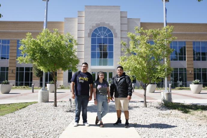 Photo of students posing in front of the Nick & Lou Martin University Center.